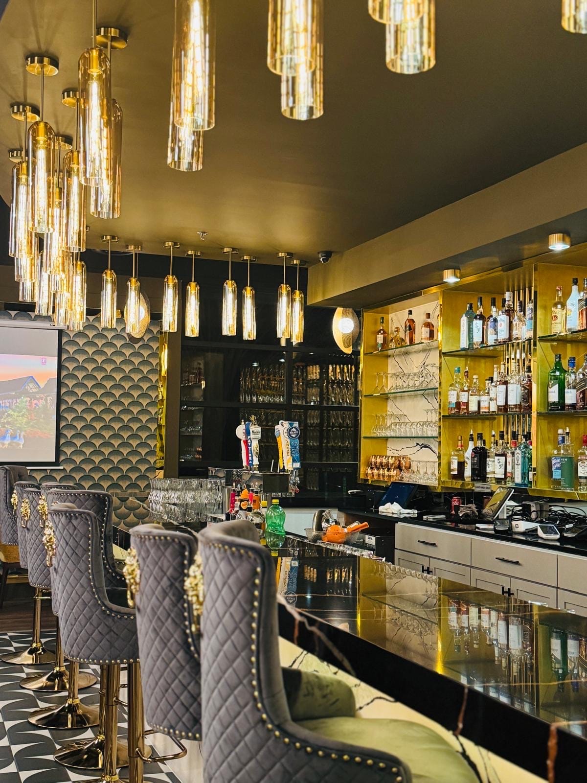 Gold bar with cascading crystal tube pendant lights