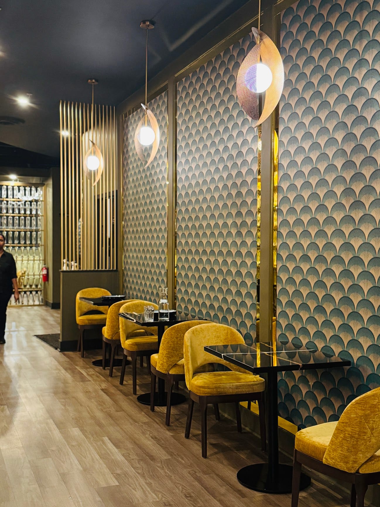 Art deco scallop wallpaper with pendant light and yellow seating